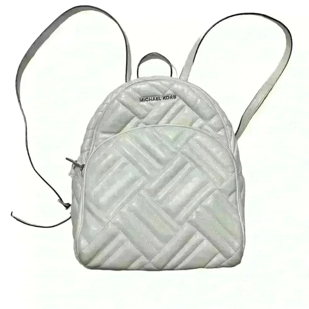 Michael‎ Kors Abbey white quilted backpack. Silver hardware. Two zipper pockets.